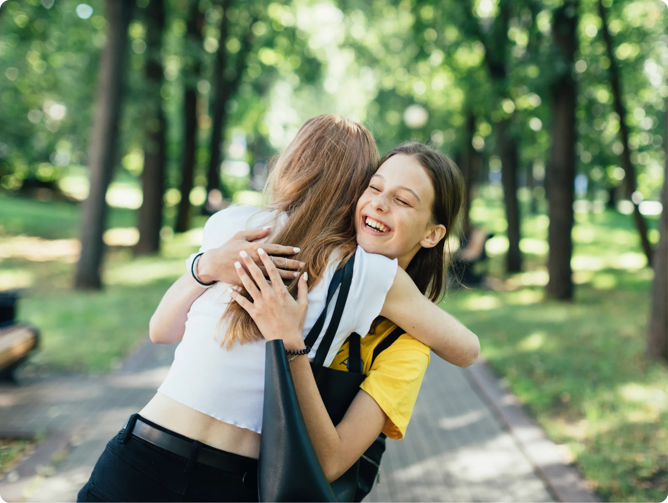 Two happy students hugging